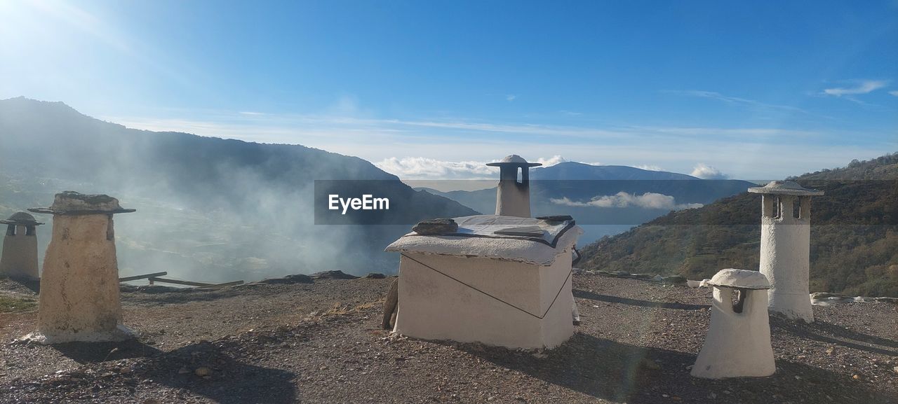 mountain, sky, nature, landscape, environment, scenics - nature, sunlight, land, travel, no people, mountain range, architecture, travel destinations, outdoors, day, fog, beauty in nature, blue, cloud, tourism, sunny