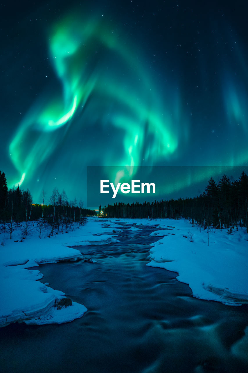 Scenic view of snowcapped mountains against sky at night