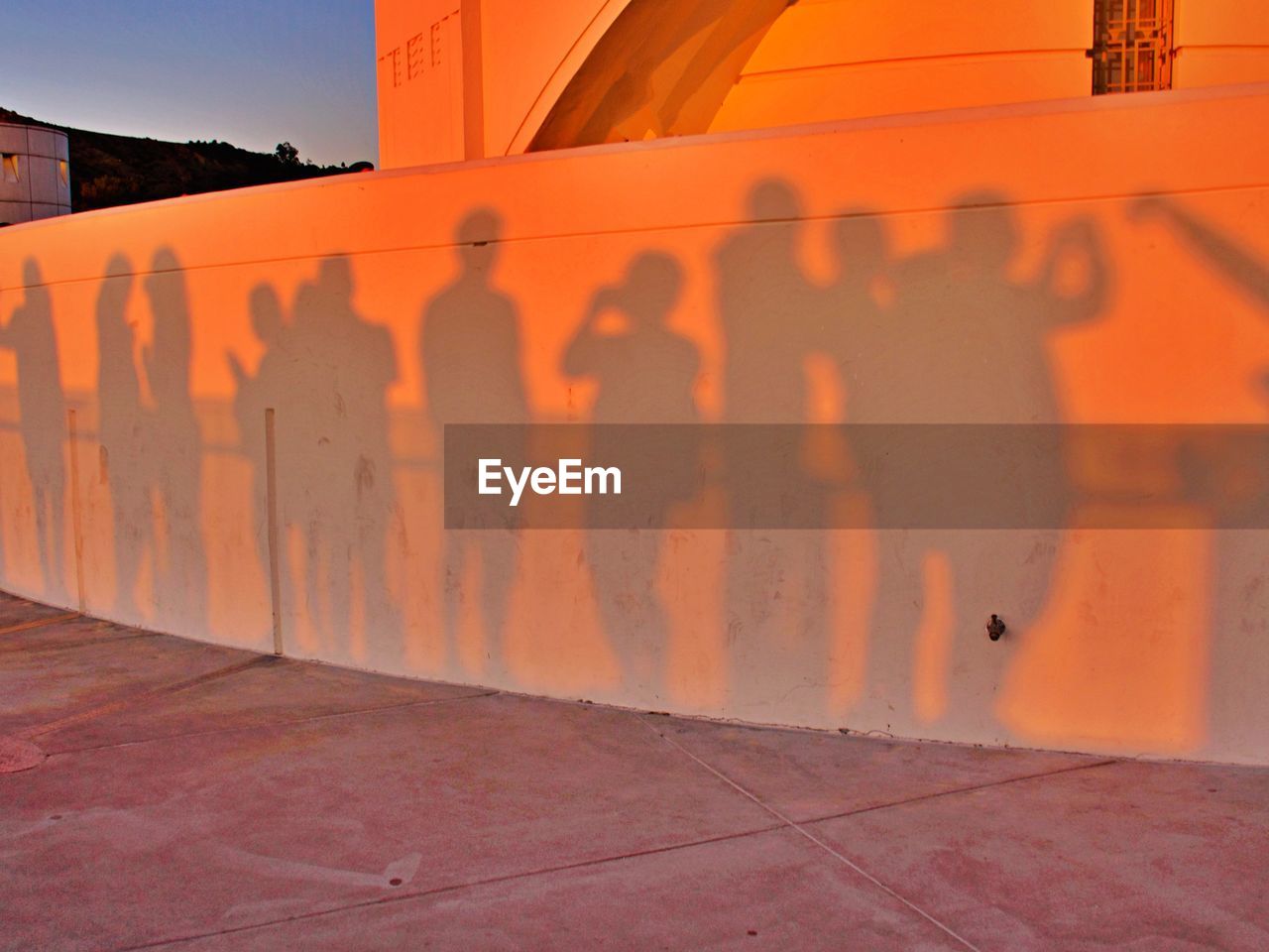 Shadow of people on orange wall