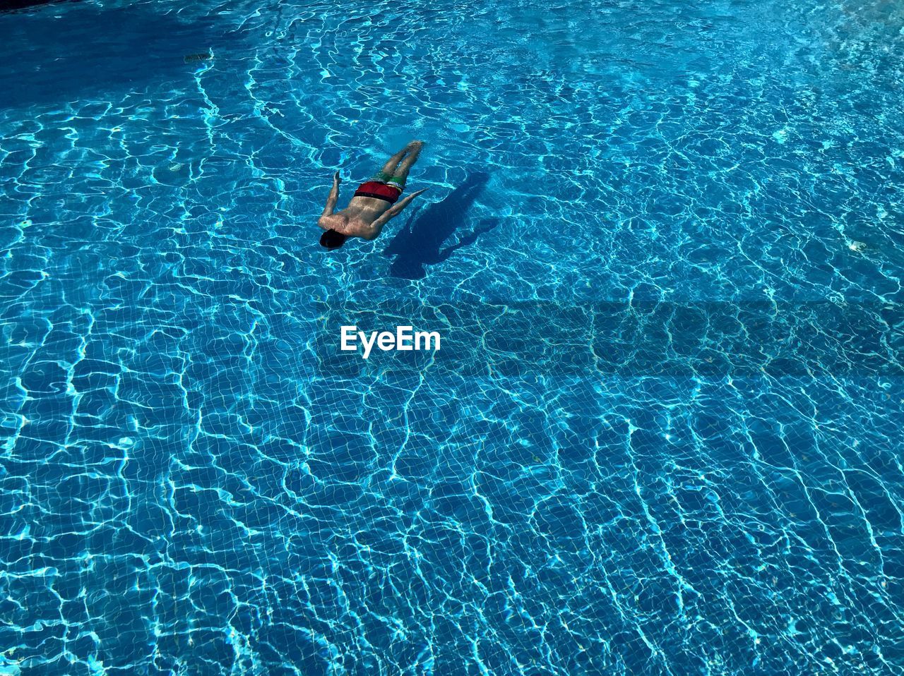 High angle view of man swimming in pool