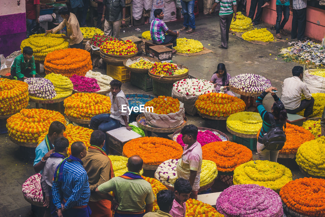 HIGH ANGLE VIEW OF PEOPLE AT MARKET