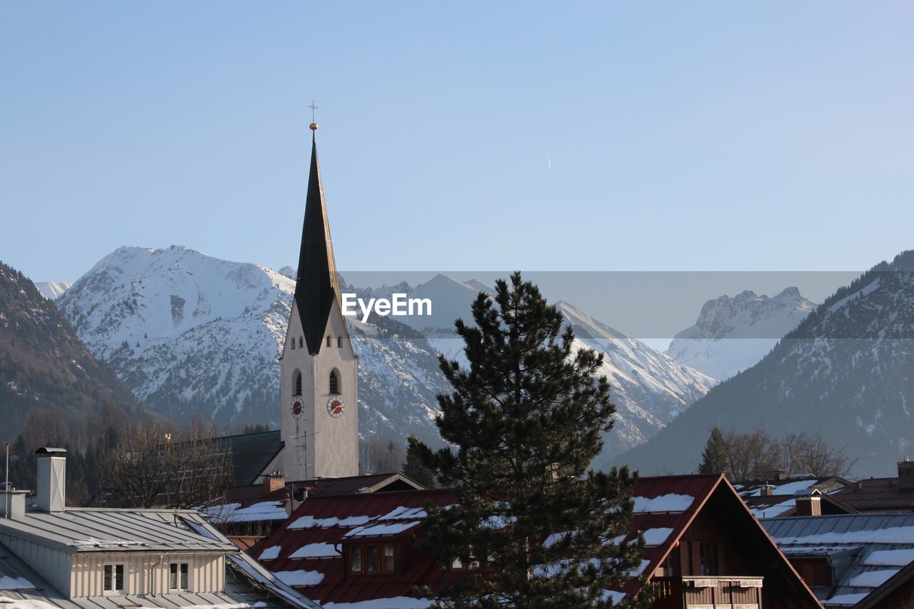 Panoramic view of buildings and mountains against sky