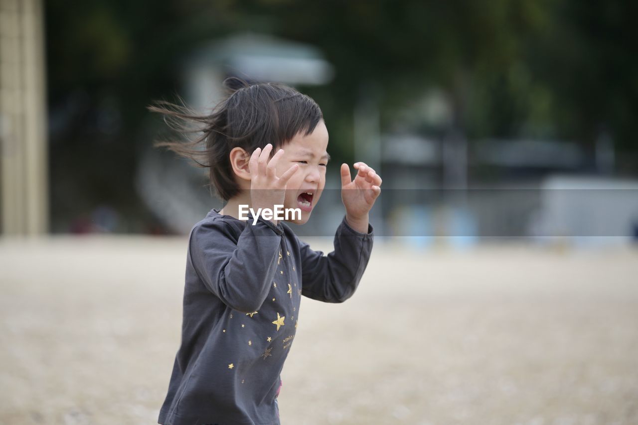 Girl crying while running outdoors