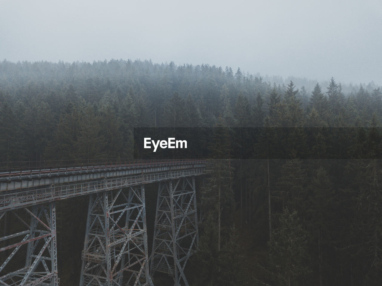 High angle view at railroad bridge in forest with a lot of fog