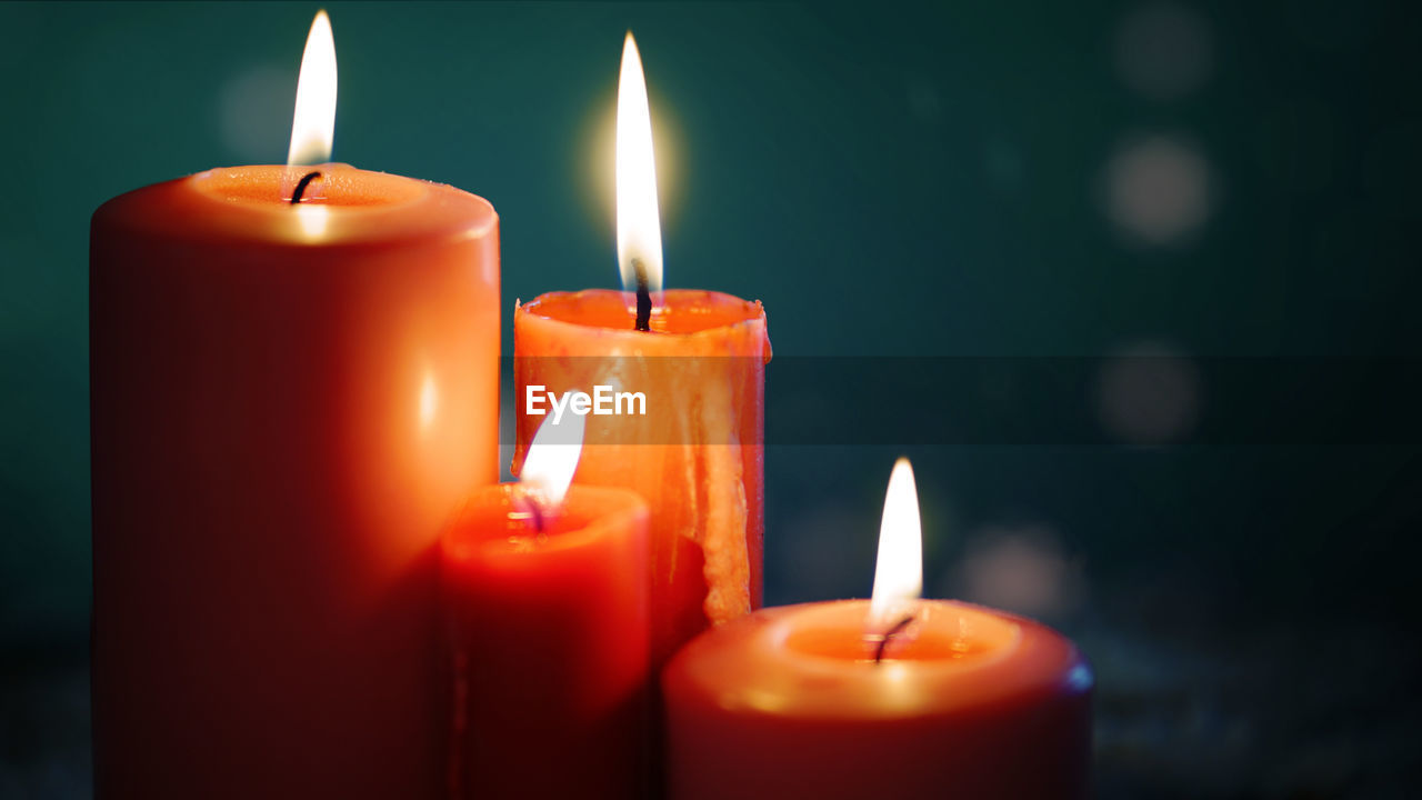 Close-up of lit candle in the dark