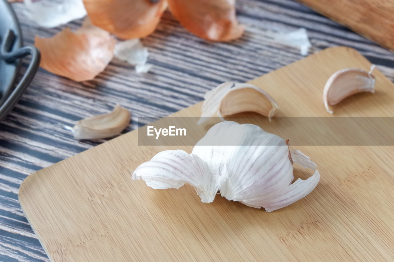 High angle view of garlic on cutting board