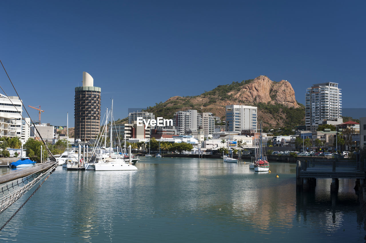 View down the quay of boats moored in the calm water of townsville marina in queensland, australia