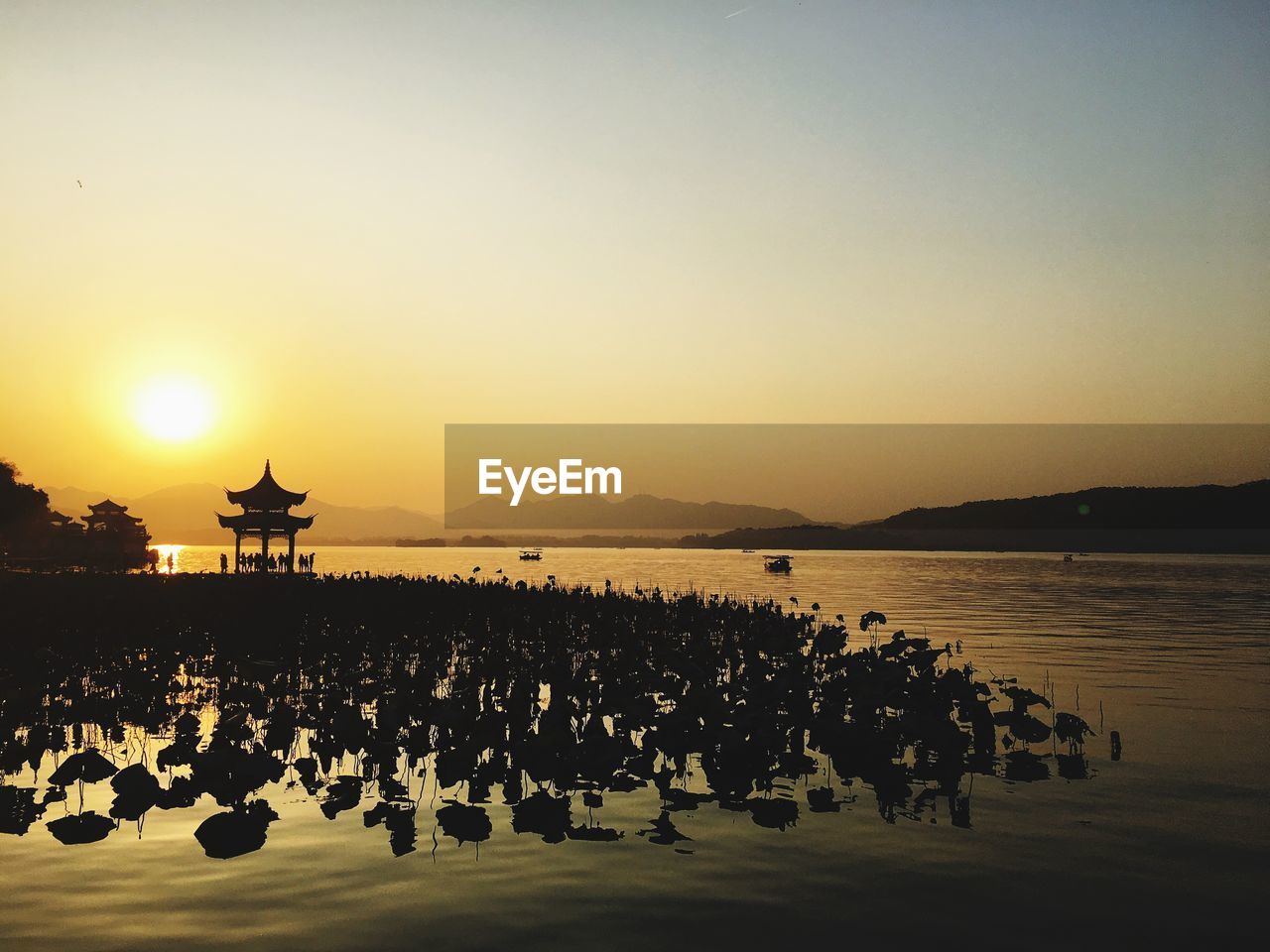 Scenic view of sea against clear sky during sunset