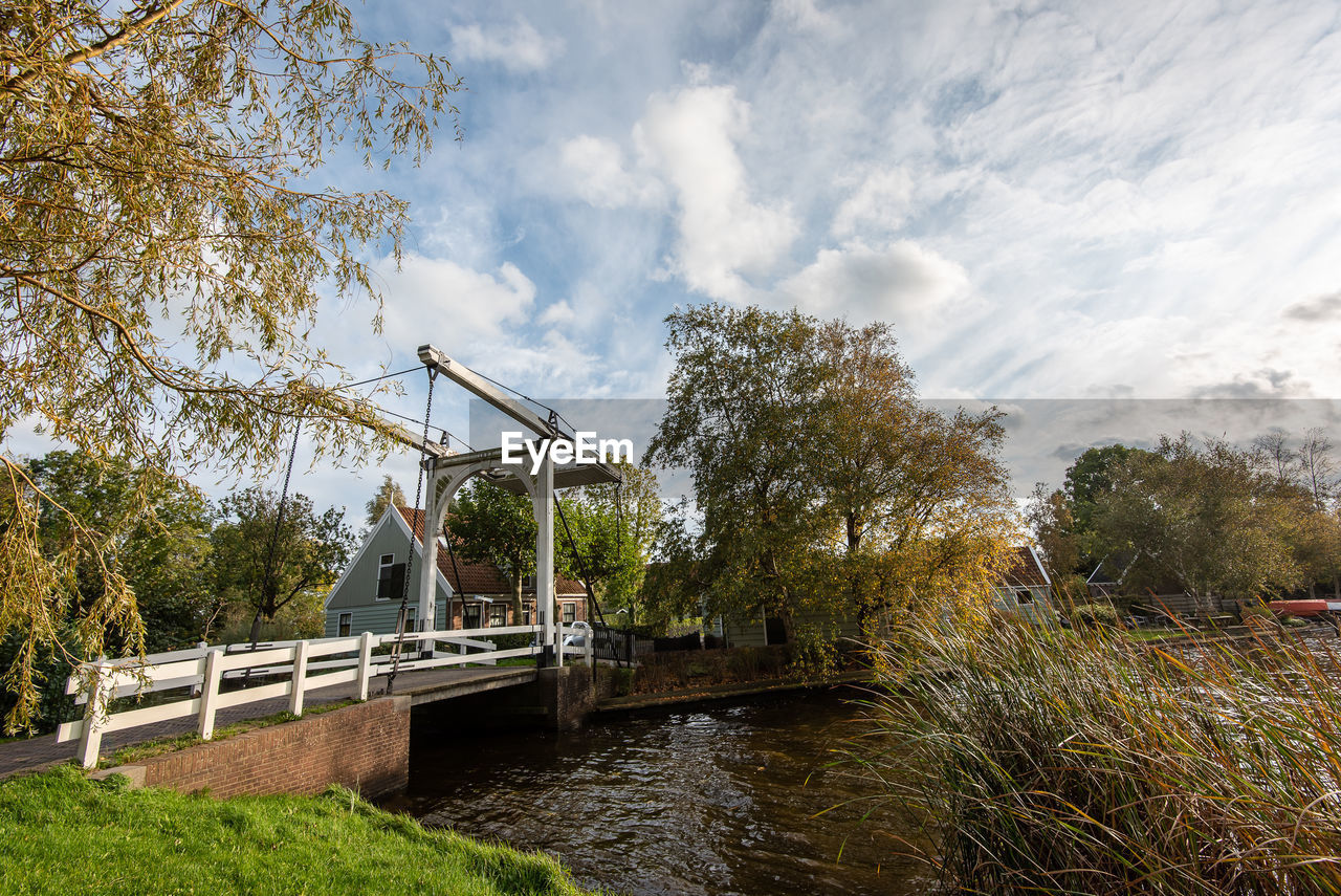 Low angle view of bridge over river against sky