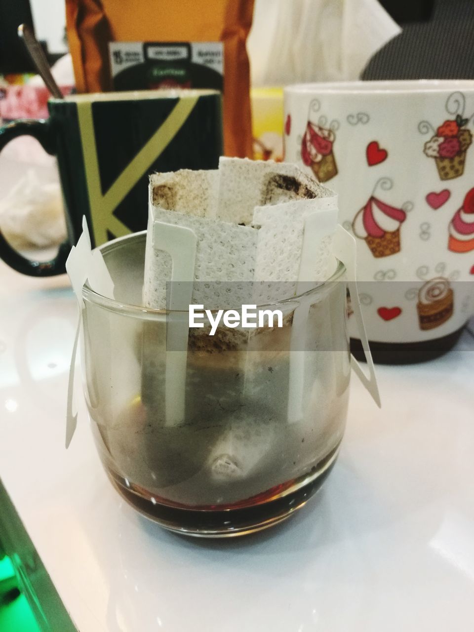 CLOSE-UP OF COFFEE WITH GLASS OF TABLE