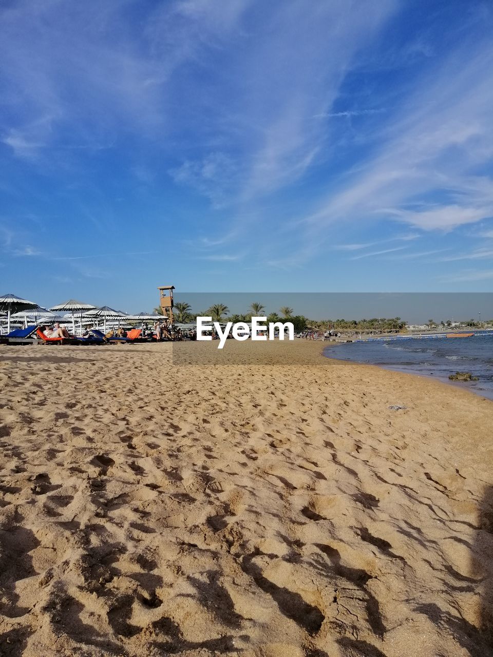 Scenic view of beach against blue sky