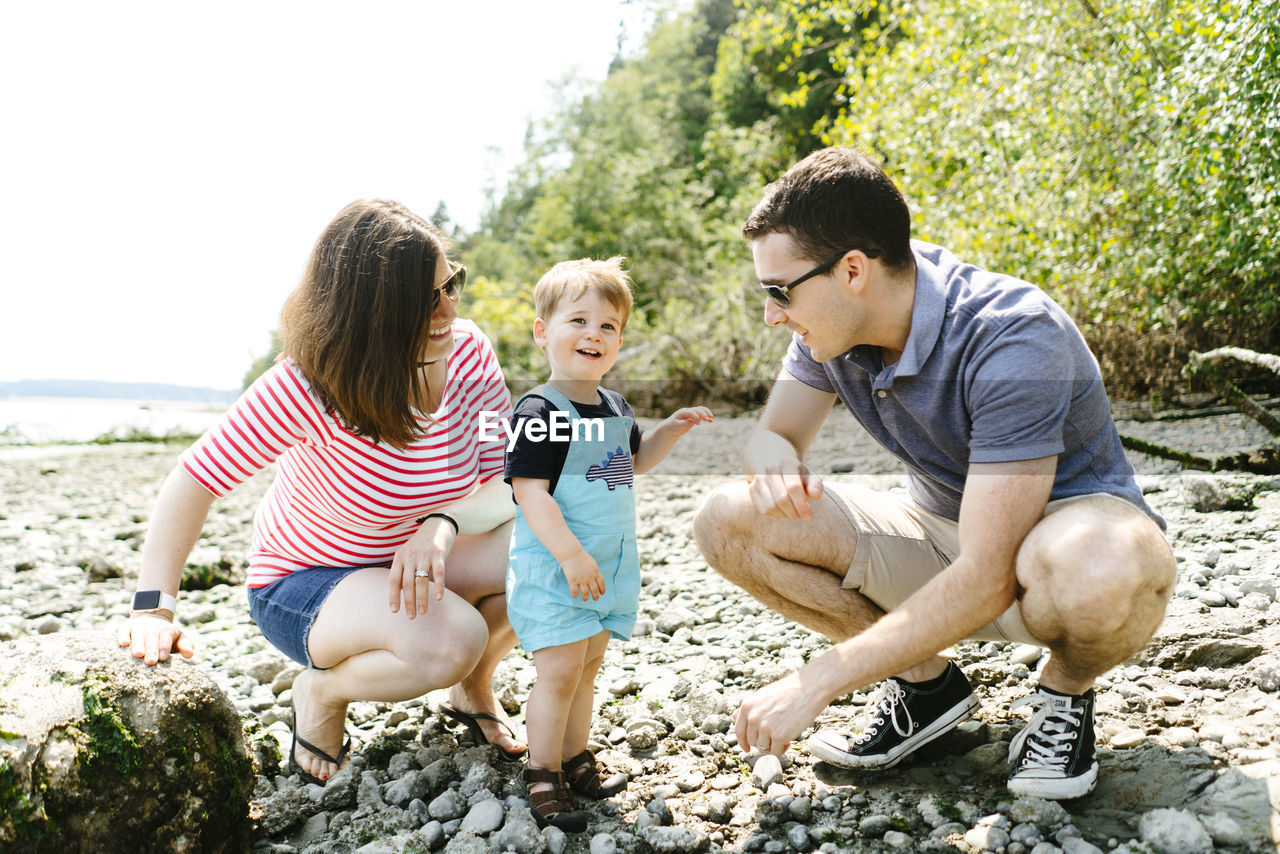 Straight on portrait of a family together on a rocky beach