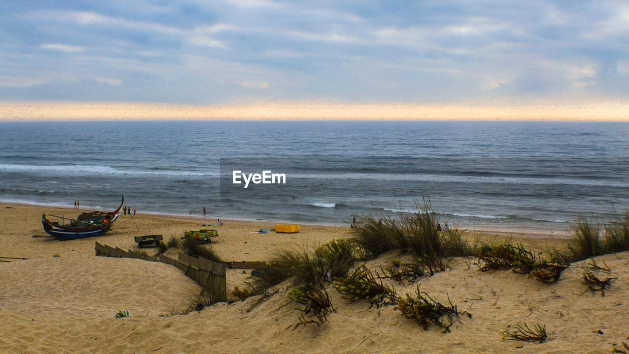 Scenic view of beach against sky during sunset