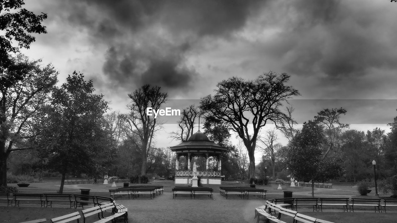 tree, plant, sky, cloud, architecture, black and white, nature, monochrome, monochrome photography, built structure, travel destinations, park, water, park - man made space, building exterior, outdoors, city, travel, bench, tourism, the past, history, day, no people