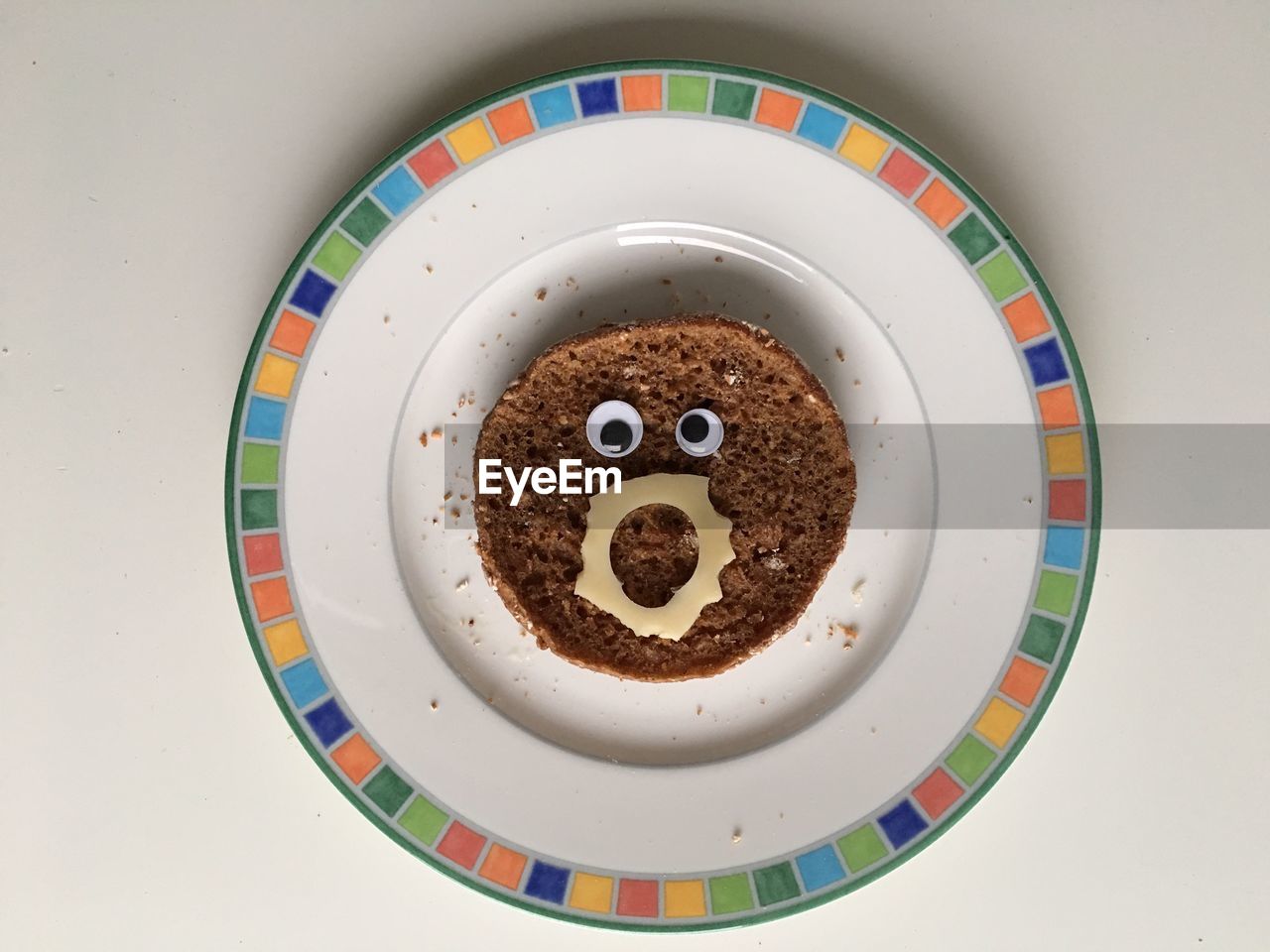 High angle view of brown bread in plate on white background