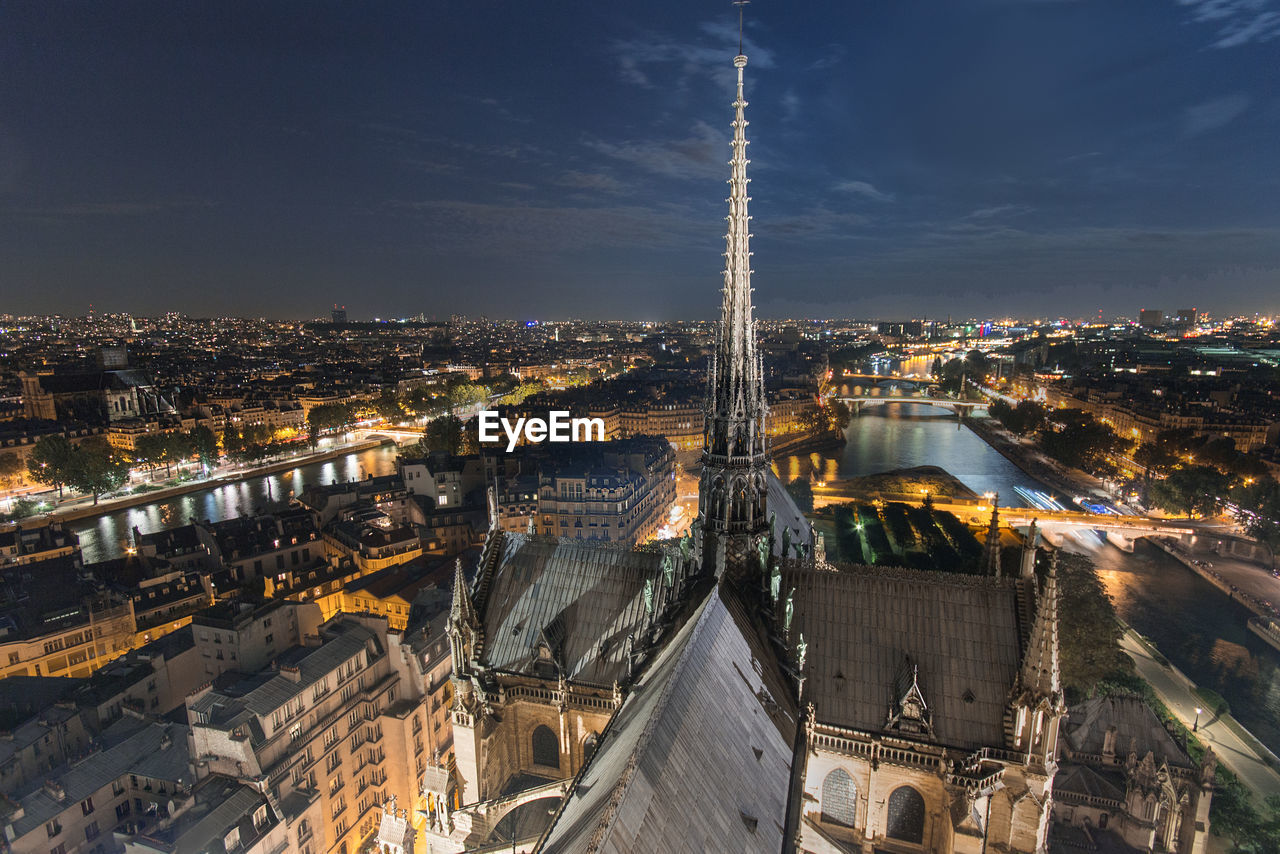 High angle view of city lit up at night