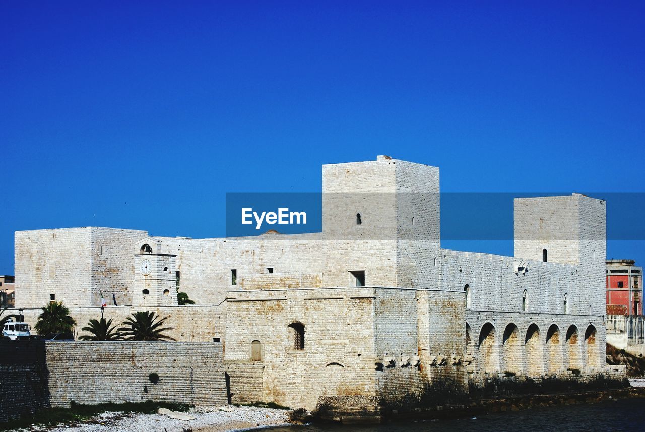 LOW ANGLE VIEW OF BLUE FORT AGAINST CLEAR SKY