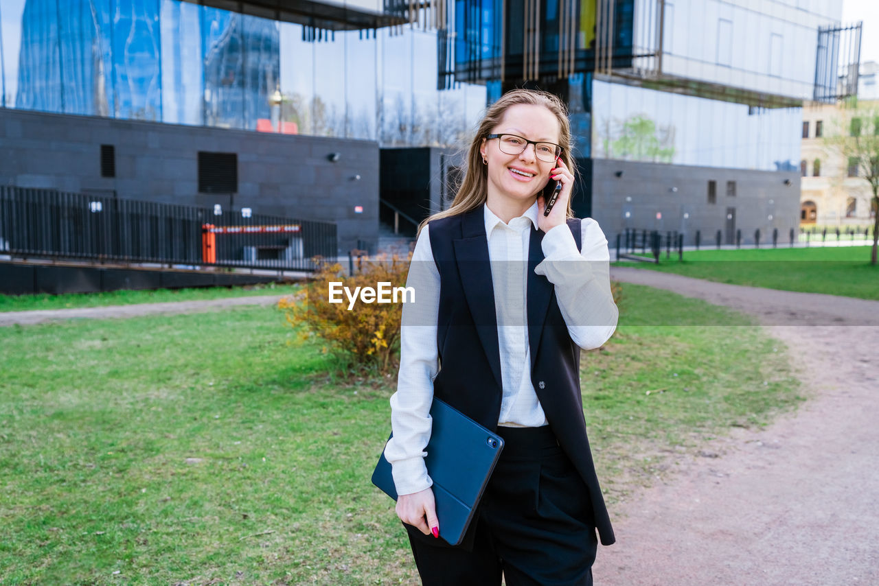 Successful businesswoman or manager, woman talking on mobile phone while