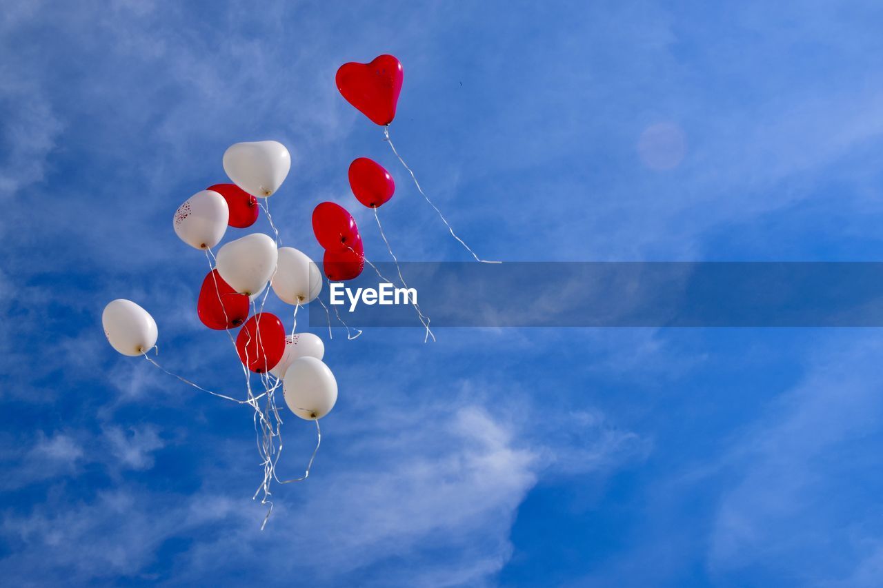 Low angle view of balloons against sky