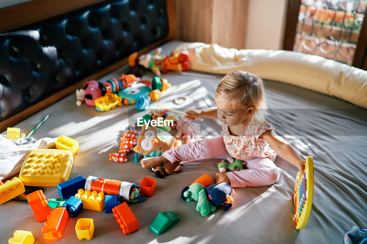 high angle view of girl playing with toys on table at home