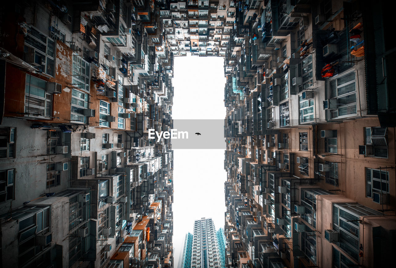 Low angle view of buildings in city against sky