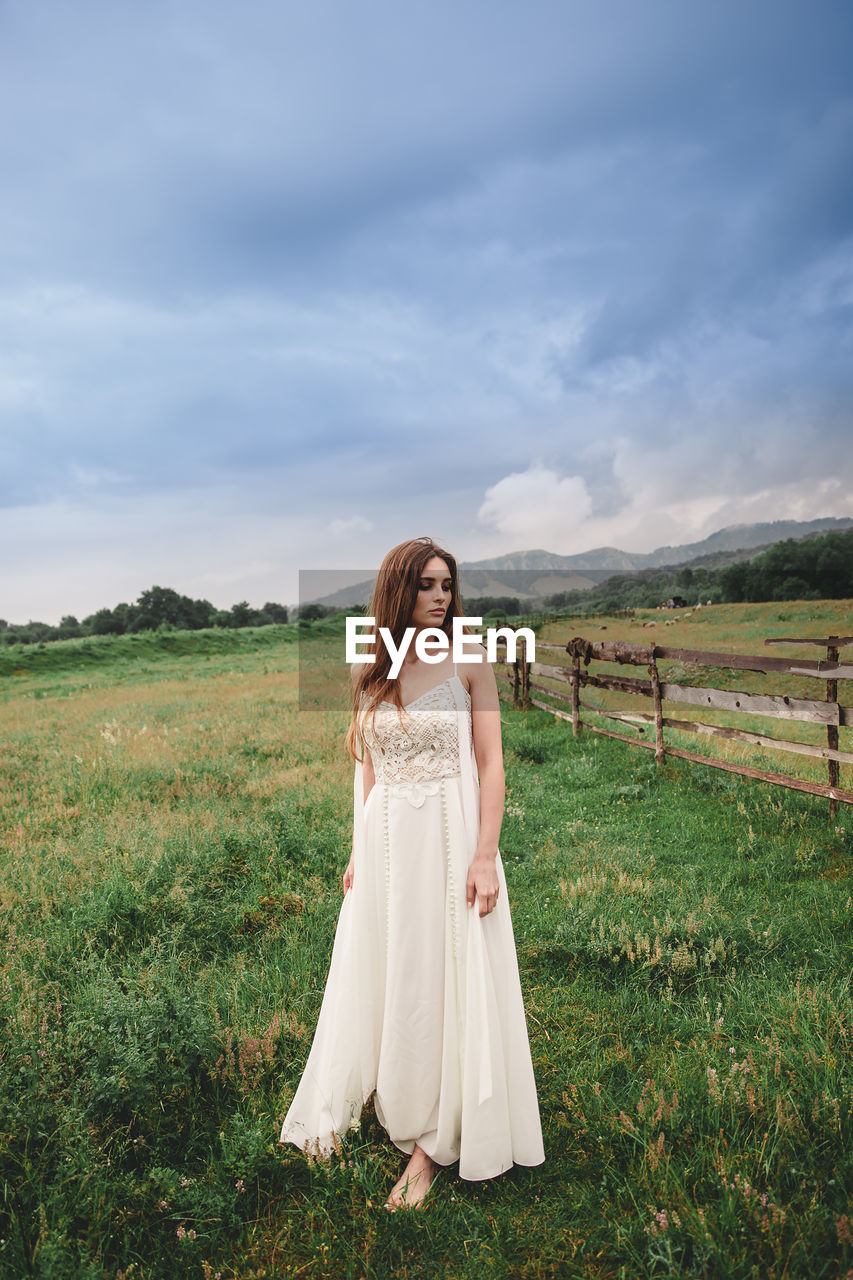 WOMAN STANDING ON FIELD