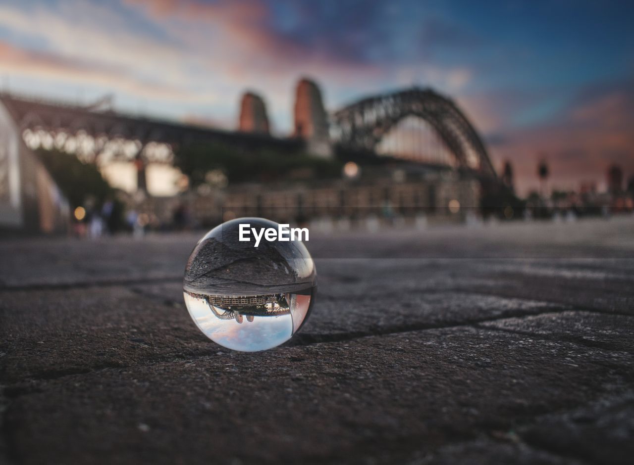 Close-up of crystal ball with sydney harbor bridge in background