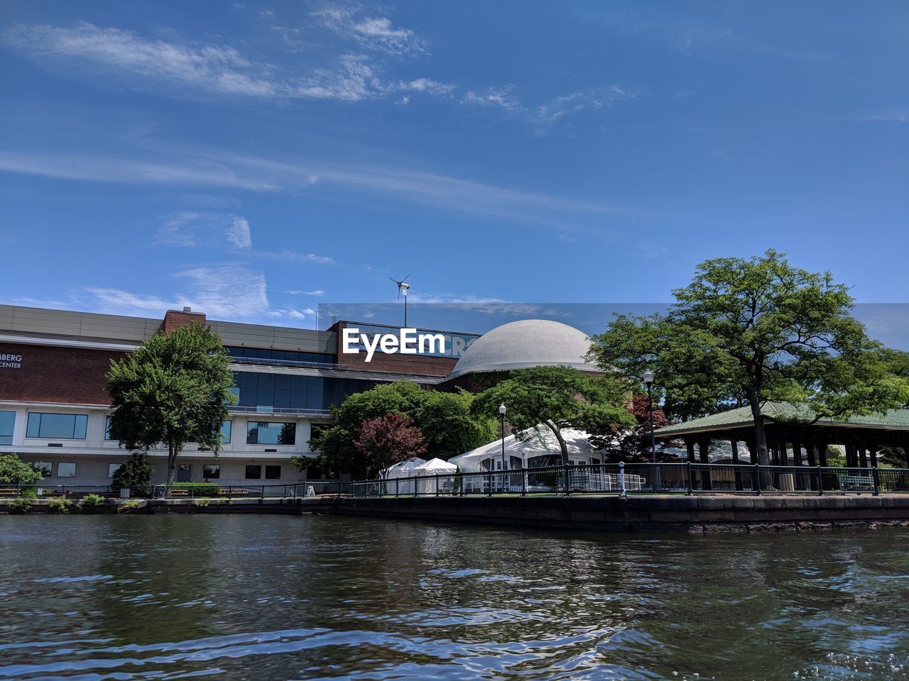 BUILDINGS IN CITY AGAINST CLOUDY SKY