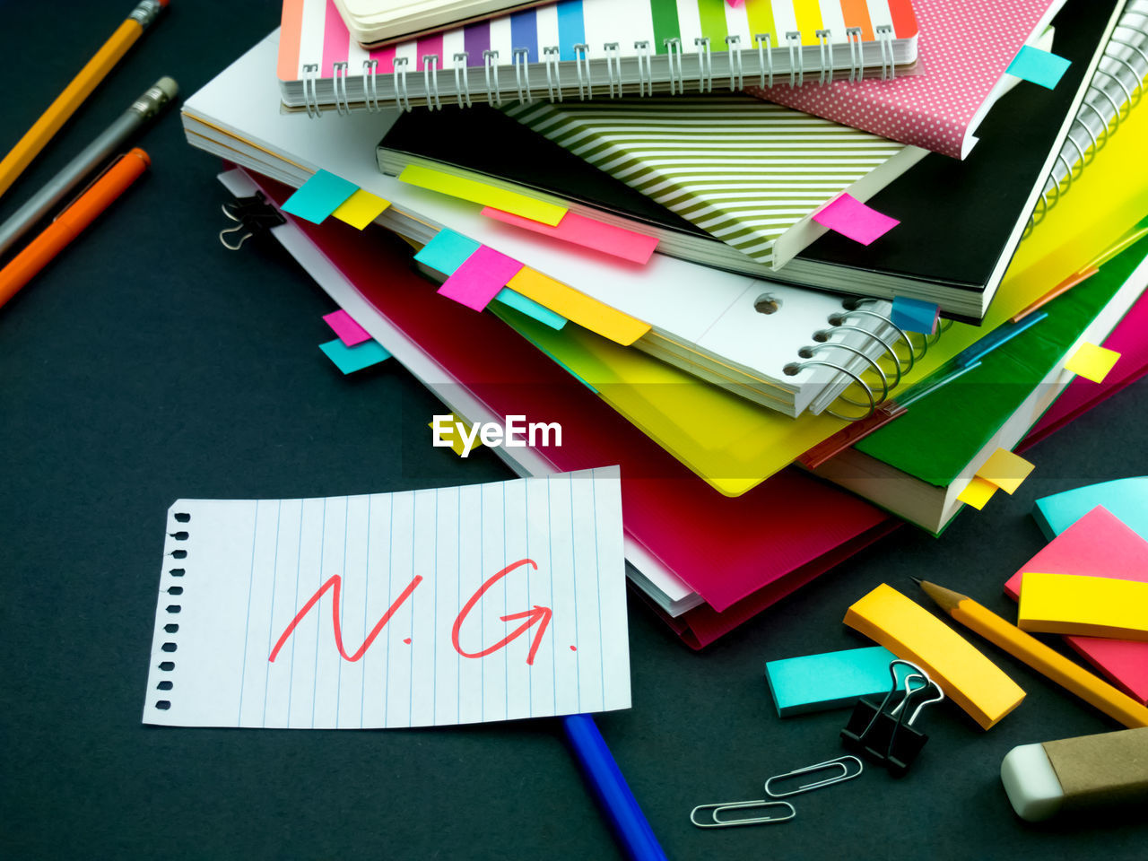 High angle view of text on paper with books at desk