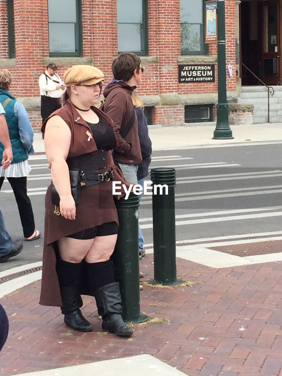 YOUNG WOMAN STANDING ON CITY STREET