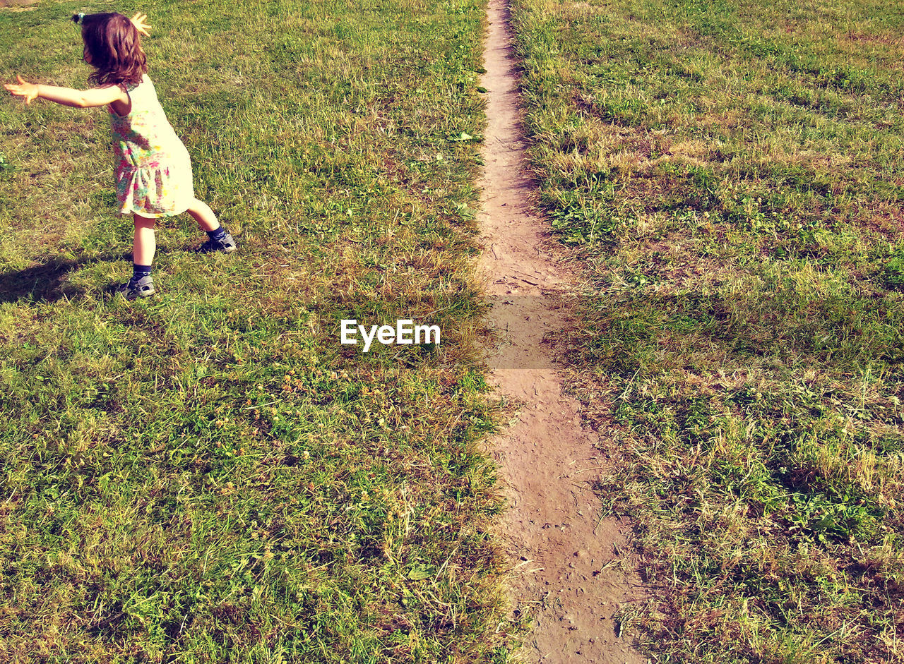 High angle view of girl walking on field