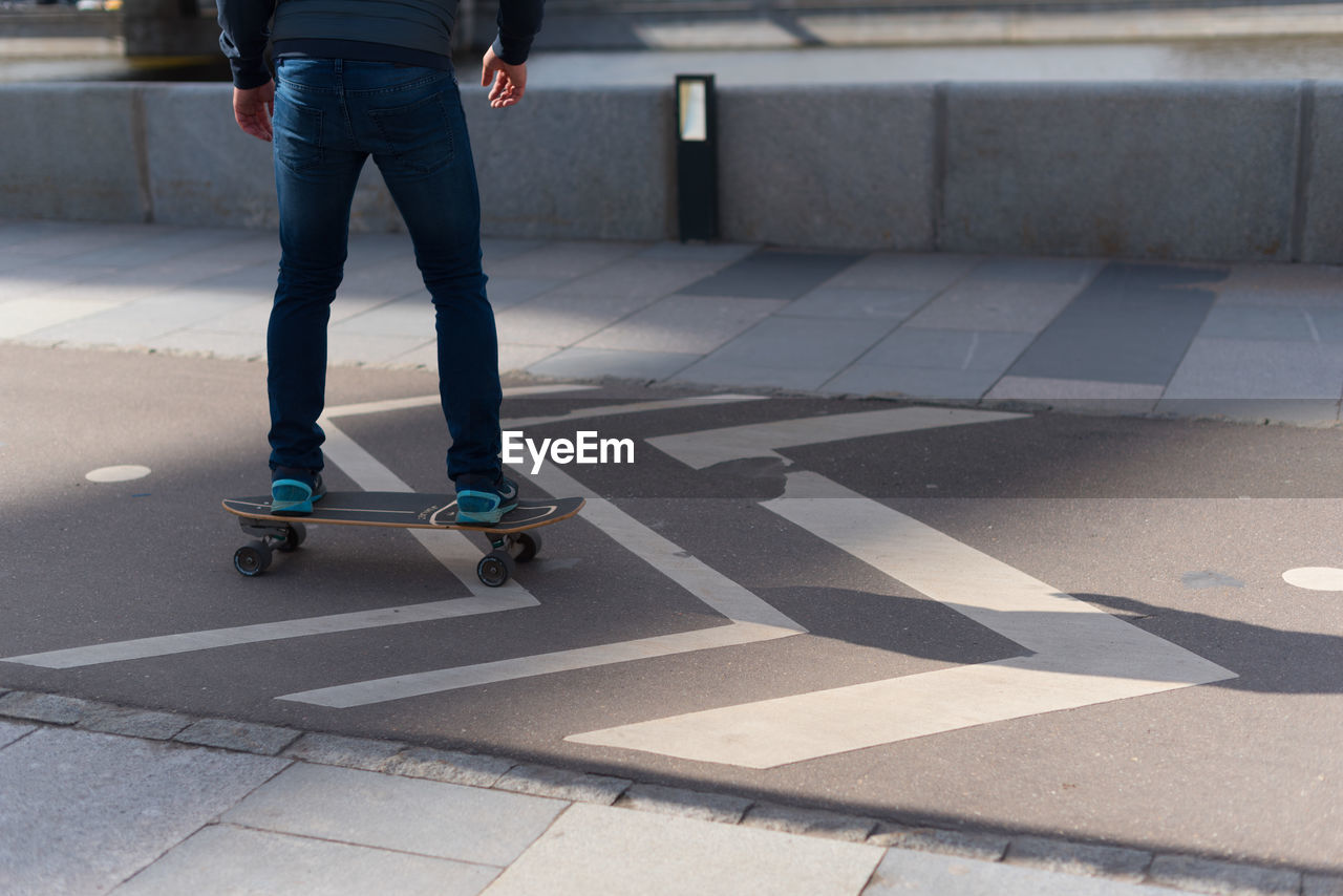 Low section of man skateboarding on skateboard park