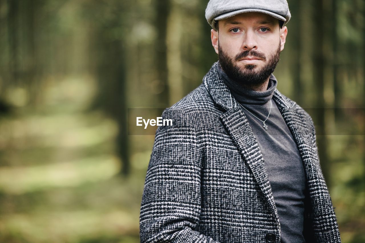 Portrait of man standing in forest