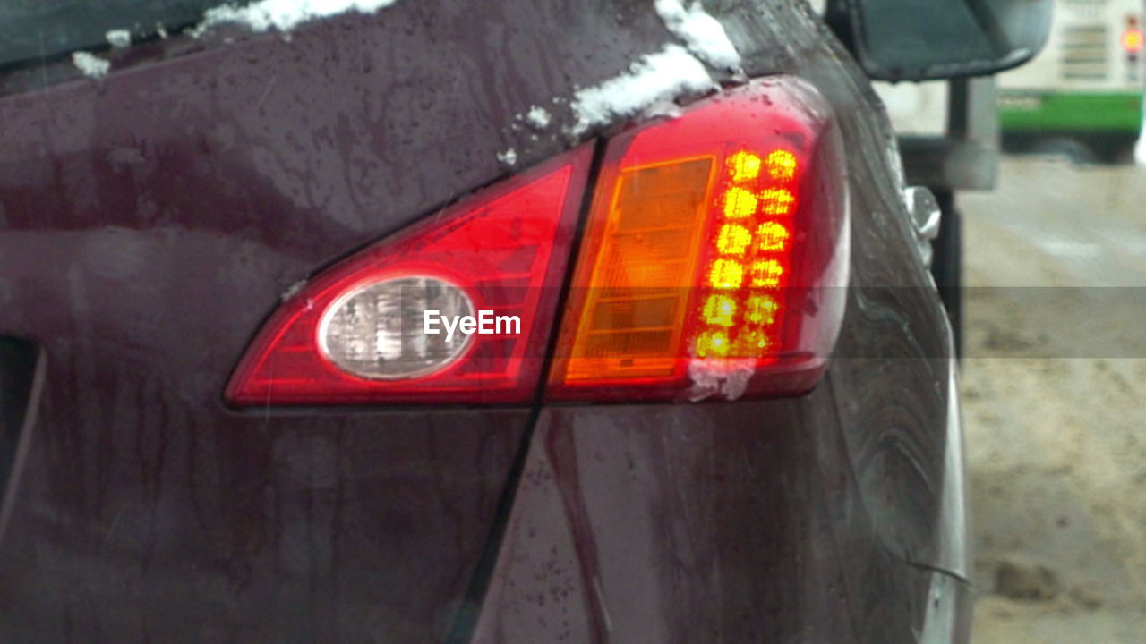 Close-up of illuminated red car in city