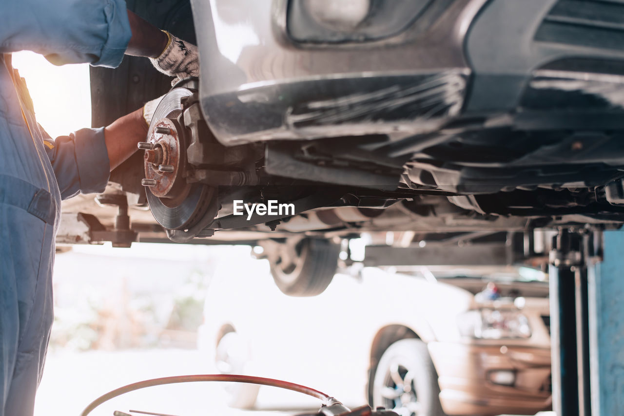 midsection of man working in car