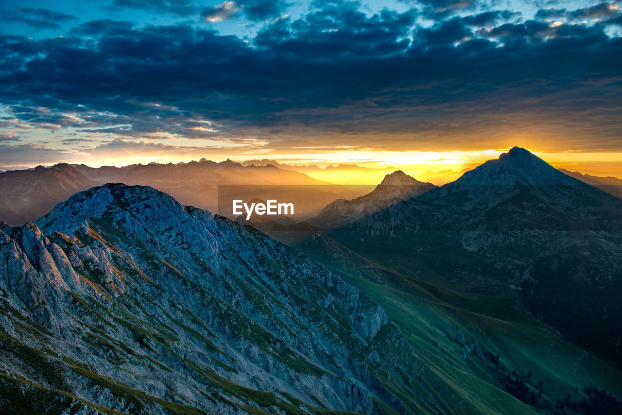 Scenic view of snowcapped mountains against sky during sunset