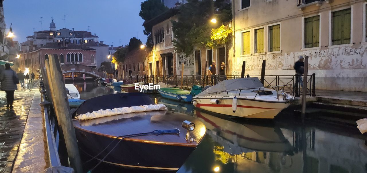 nautical vessel, architecture, water, building exterior, transportation, mode of transportation, built structure, boat, canal, gondola, city, waterway, travel destinations, moored, travel, illuminated, reflection, nature, vehicle, tourism, watercraft, building, night, no people, outdoors, street, sky, holiday, ship, evening, town, vacation