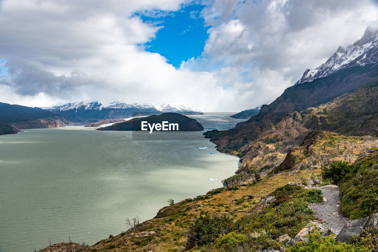 Scenic view of lake and mountains against sky