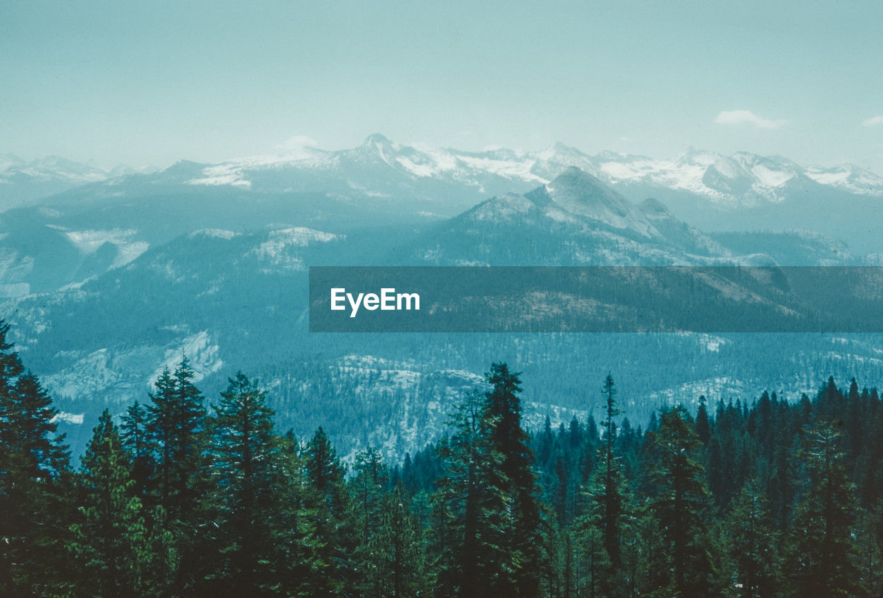 high angle view of trees and mountains against sky