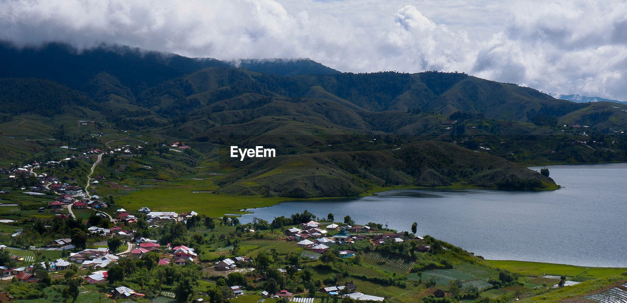 Scenic view of lake and mountains against sky