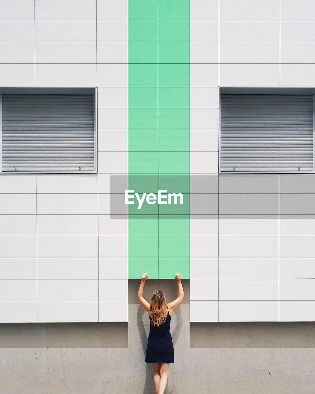 Woman standing against building