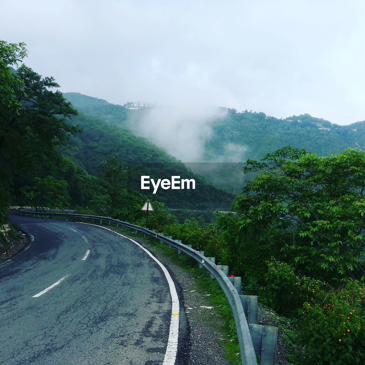 Empty road with mountains in background