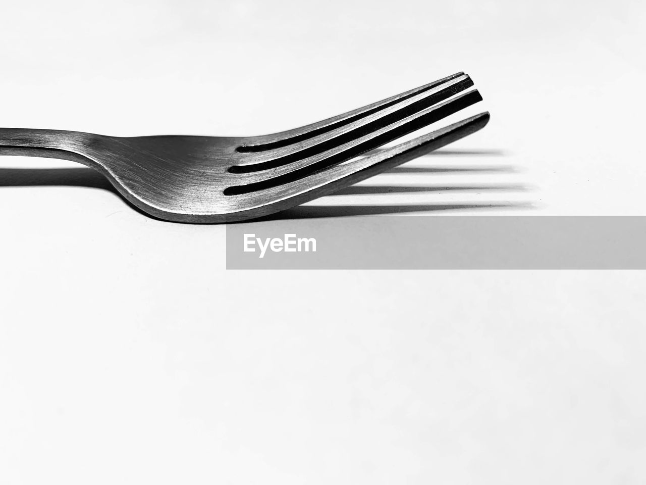 close-up of fork over white background