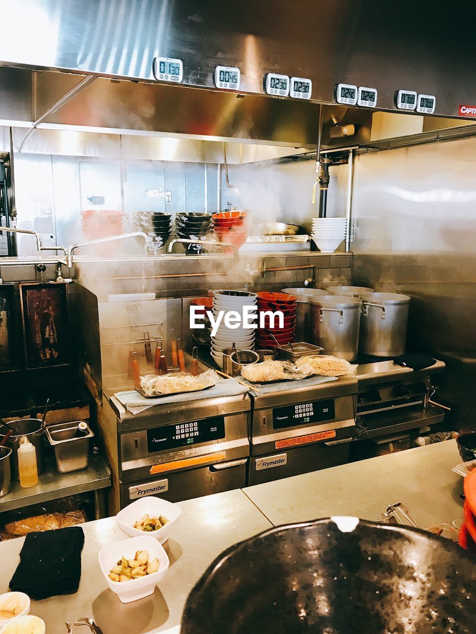 CLOSE-UP OF PREPARING FOOD IN KITCHEN AT RESTAURANT