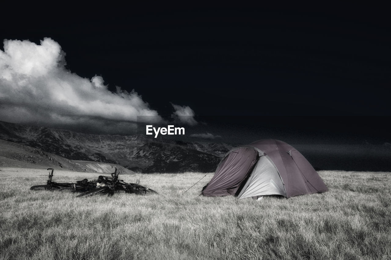 TENTS ON FIELD AGAINST SKY