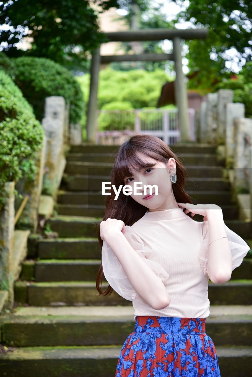 Young woman standing on staircase