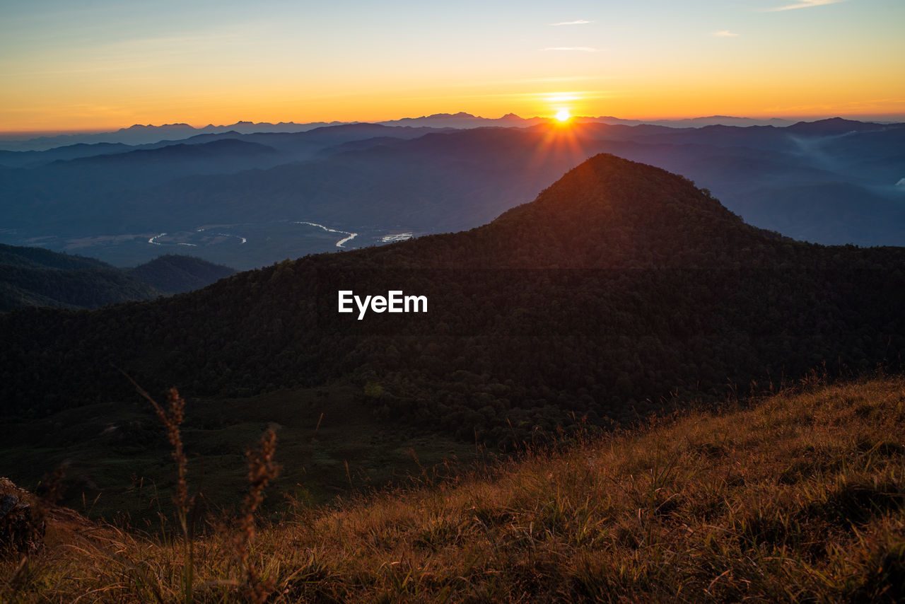 Scenic view of mountains against sky during sunset