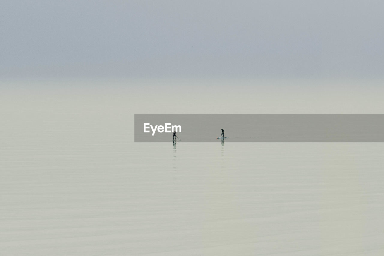 Two people on paddleboard enjoying endless ocean