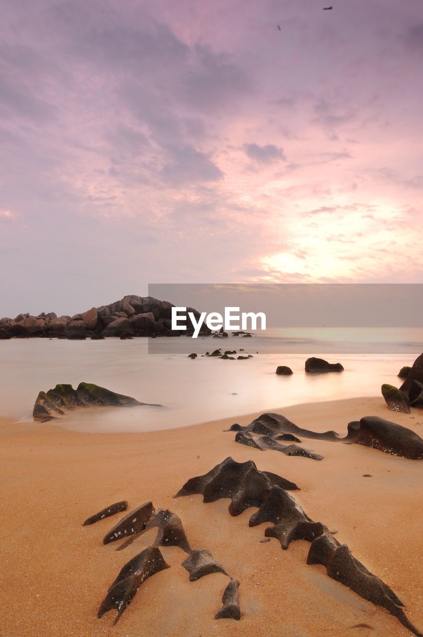 Scenic view of beach against sky during sunset