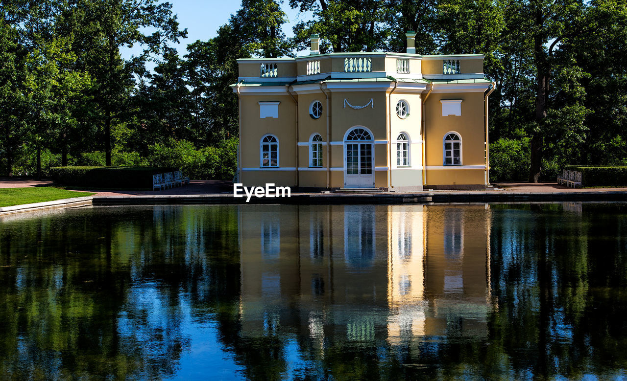 Reflection of trees and building in lake